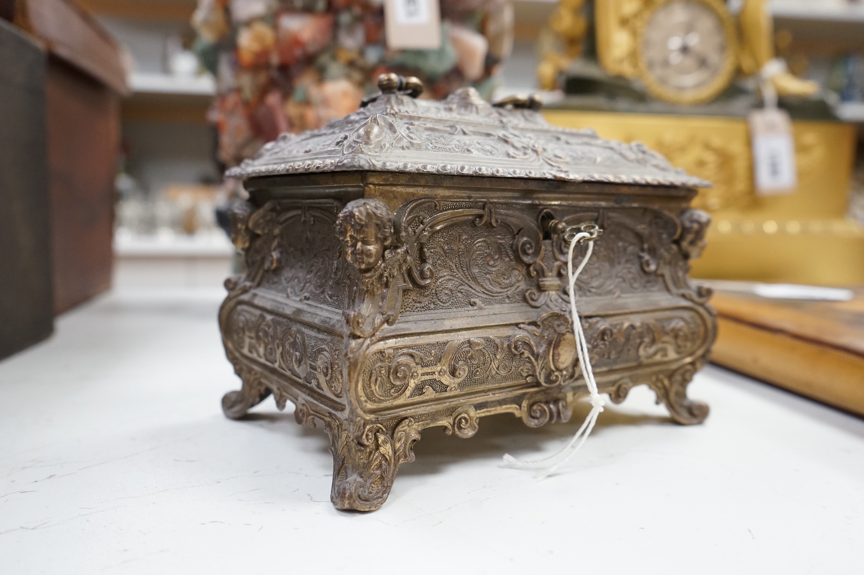 A rococo-style rectangular bronze casket and key, 17cm wide